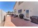 Backyard patio area with outdoor grill and access to hot tub and pergola covered outdoor seating area at 690 Great Dane Ct, Henderson, NV 89052