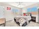 This well-lit bedroom features a ceiling fan and two large windows at 690 Great Dane Ct, Henderson, NV 89052