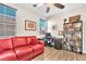 Cozy bedroom featuring a comfortable red couch, modern desk and ample bookshelves at 690 Great Dane Ct, Henderson, NV 89052
