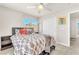 This well-lit bedroom features a ceiling fan, two windows and a closet with sliding doors at 690 Great Dane Ct, Henderson, NV 89052