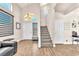 Open foyer with hardwood floors, a staircase, and natural light at 690 Great Dane Ct, Henderson, NV 89052