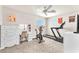 This bonus room has an exercise bike, treadmill and wall-mounted television at 690 Great Dane Ct, Henderson, NV 89052