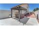 Backyard with pergola-covered hot tub and adjacent outdoor lounge area, perfect for relaxation at 690 Great Dane Ct, Henderson, NV 89052