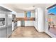 Bright kitchen with stainless steel appliances, white cabinets, and access to the backyard at 690 Great Dane Ct, Henderson, NV 89052