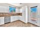 Updated kitchen with stainless steel appliances, granite counters and access to the patio at 690 Great Dane Ct, Henderson, NV 89052