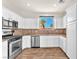 Contemporary kitchen with stainless steel appliances and white cabinets at 690 Great Dane Ct, Henderson, NV 89052