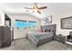 Main bedroom with a large bed, modern dresser, carpet and sunny windows at 690 Great Dane Ct, Henderson, NV 89052