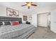 Main bedroom featuring a large bed, modern furniture, carpet and a walk in closet at 690 Great Dane Ct, Henderson, NV 89052