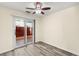 Bedroom with updated ceiling fan, sliding door backyard access, and wood look flooring at 727 Heritage Vista Ave, Henderson, NV 89015