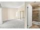 Bright bedroom featuring plush gray carpeting, sliding closet doors, and an attached bathroom at 727 Heritage Vista Ave, Henderson, NV 89015