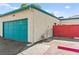 Exterior view of a home showcasing the turquoise garage door and partial fencing at 727 Heritage Vista Ave, Henderson, NV 89015