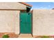 A close-up view of the front gate featuring a green door and red rock landscape at 727 Heritage Vista Ave, Henderson, NV 89015