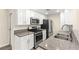 Updated kitchen featuring stainless steel appliances and granite countertops with white cabinets at 727 Heritage Vista Ave, Henderson, NV 89015