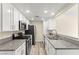 Well-lit kitchen featuring modern appliances, granite countertops, and ample cabinet space for efficient meal preparation at 727 Heritage Vista Ave, Henderson, NV 89015