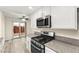 Modern kitchen featuring stainless steel appliances, granite countertops, and backyard access at 727 Heritage Vista Ave, Henderson, NV 89015