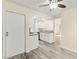 Bright kitchen with wood-look flooring, stainless appliances and open view into the living room at 727 Heritage Vista Ave, Henderson, NV 89015
