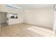 Spacious living room with tiled flooring showcasing an open kitchen view and a sliding glass door at 727 Heritage Vista Ave, Henderson, NV 89015