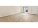 Bright, tiled living room featuring a sliding glass door and a white door at 727 Heritage Vista Ave, Henderson, NV 89015