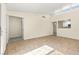 Open-concept living room featuring tile floors, white trim, and access to the entryway and kitchen at 727 Heritage Vista Ave, Henderson, NV 89015