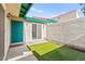 Cozy patio showcasing an artificial lawn and a green door with red trim accents at 727 Heritage Vista Ave, Henderson, NV 89015