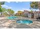 Community pool and hot tub surrounded by lush landscaping and lounge chairs, perfect for relaxation and recreation at 727 Heritage Vista Ave, Henderson, NV 89015
