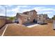The backyard features desert landscaping and a concrete patio with a built in grill at 7288 Quarterhorse Ln, Las Vegas, NV 89148
