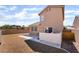The backyard features desert landscaping and a concrete patio with a built in grill at 7288 Quarterhorse Ln, Las Vegas, NV 89148