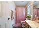 Bathroom features a sink and a shower covered by a pink shower curtain at 7288 Quarterhorse Ln, Las Vegas, NV 89148