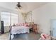 Cozy bedroom featuring large window, a bed with decorative pillows, and whimsical decor at 7288 Quarterhorse Ln, Las Vegas, NV 89148