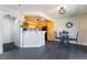 Charming dining area with kitchen access, black tile flooring and modern light fixture at 7288 Quarterhorse Ln, Las Vegas, NV 89148