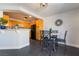 View of the dining area with black appliances, bright cabinets, and black tile flooring at 7288 Quarterhorse Ln, Las Vegas, NV 89148