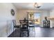 Comfortable dining area with view of outdoor patio, modern light fixture and black tile flooring at 7288 Quarterhorse Ln, Las Vegas, NV 89148