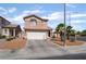 Inviting two-story home with a spacious driveway and desert-style landscaping at 7288 Quarterhorse Ln, Las Vegas, NV 89148