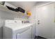 Convenient laundry room equipped with modern washer and dryer units, as well as built-in shelving at 7288 Quarterhorse Ln, Las Vegas, NV 89148