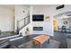 Spacious living area featuring a modern fireplace, black tile flooring, and open access to dining area at 7288 Quarterhorse Ln, Las Vegas, NV 89148