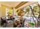 Relaxing balcony featuring comfortable seating and beautiful trees at 7648 Rolling View Dr # 201, Las Vegas, NV 89149