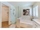 Modern bathroom with glass enclosed shower, soaking tub, and access to a walk-in closet at 7648 Rolling View Dr # 201, Las Vegas, NV 89149