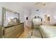 Spacious bedroom featuring hardwood floors, a seating area, and access to the bathroom at 7648 Rolling View Dr # 201, Las Vegas, NV 89149