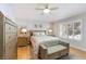 Well decorated bedroom featuring a ceiling fan, plantation shutters, and stylish mirrored dressers at 7648 Rolling View Dr # 201, Las Vegas, NV 89149