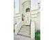 Inviting entrance with a white door and steps leading up to the home at 7648 Rolling View Dr # 201, Las Vegas, NV 89149