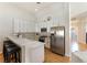 Modern kitchen featuring white cabinetry, stainless steel appliances, and breakfast bar at 7648 Rolling View Dr # 201, Las Vegas, NV 89149