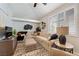 Cozy living room with an L-shaped couch, plantation shutters and stylish decor at 7648 Rolling View Dr # 201, Las Vegas, NV 89149