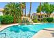 Beautiful pool with waterfall feature surrounded by lush tropical landscaping in a well maintained community at 7648 Rolling View Dr # 201, Las Vegas, NV 89149