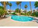 Community pool area with palm trees and a waterfall feature offering a resort-like experience for residents at 7648 Rolling View Dr # 201, Las Vegas, NV 89149