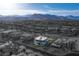 Aerial shot of an estate home with modern architectural design and desert landscape in community at 8 Meadowhawk Ln, Las Vegas, NV 89135