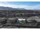 Aerial view of an architectural home with modern design and lush landscaping in a gated community at 8 Meadowhawk Ln, Las Vegas, NV 89135