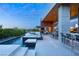 Beautiful backyard with a modern pool and spa, an outdoor kitchen and plenty of seating at 8 Meadowhawk Ln, Las Vegas, NV 89135