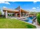 Luxury backyard with pool, lounge seating, and an outdoor kitchen for entertaining at 8 Meadowhawk Ln, Las Vegas, NV 89135