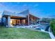 Modern home with a large backyard, infinity pool, and outdoor seating area at 8 Meadowhawk Ln, Las Vegas, NV 89135