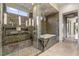 Beautiful bathroom featuring a glass-enclosed shower, soaking tub, and mosaic tile accents for a luxurious feel at 8 Meadowhawk Ln, Las Vegas, NV 89135